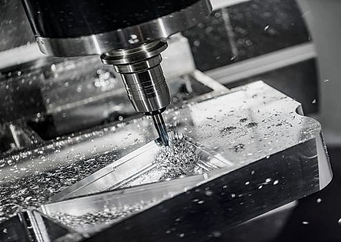 Metalworking CNC milling machine. Cutting metal modern processing technology. Small depth of field. Warning - authentic shooting in challenging conditions. A little bit grain and maybe blurred.
